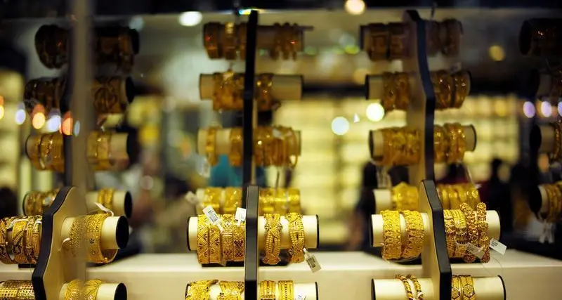 Gold hovers near one-week low as firmer US dollar, yields weigh